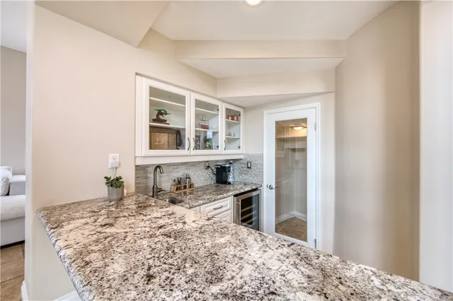 a bed sitting in a bedroom next to a window and dresser