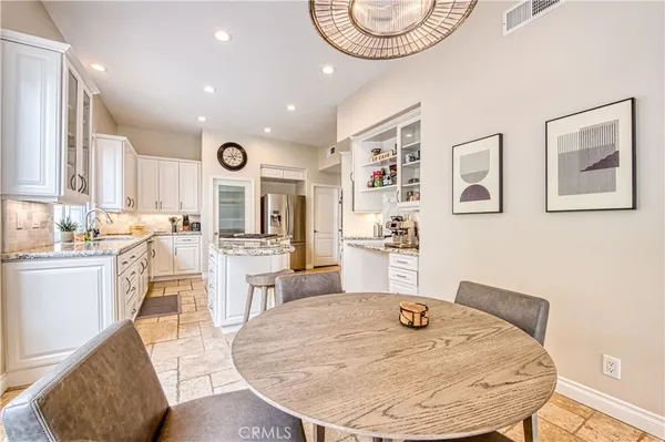 a kitchen with stainless steel appliances kitchen island granite countertop a sink and cabinets