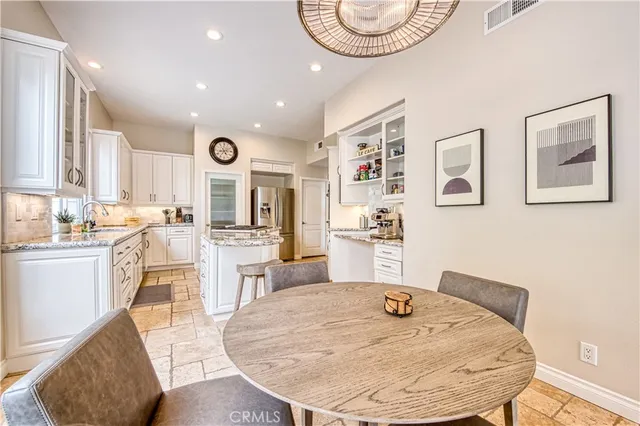 a kitchen with stainless steel appliances kitchen island granite countertop a sink and cabinets