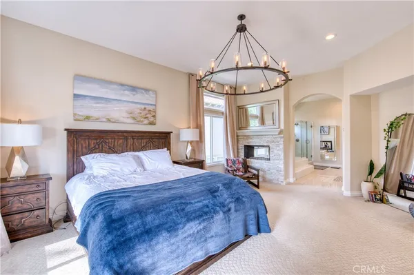 a bedroom with a bed and a chandelier