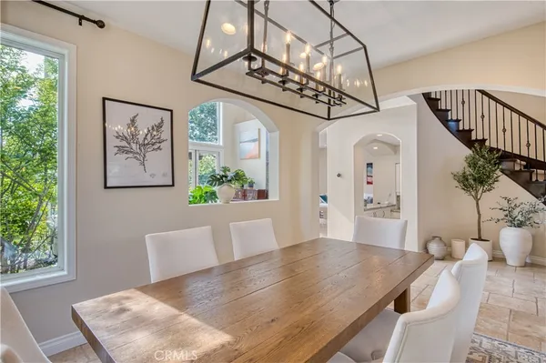 a view of a dining room with furniture and a chandelier