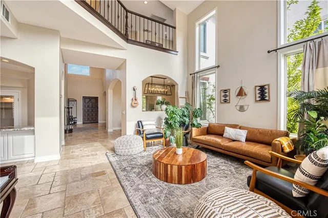 a living room with furniture and a potted plant