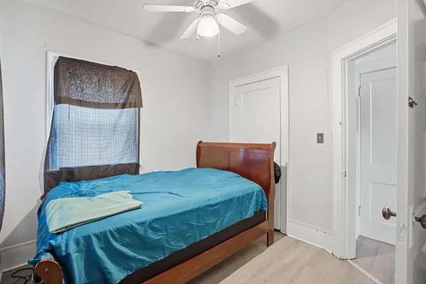 a bedroom with a bed and a chandelier