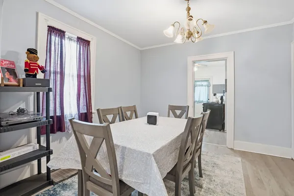 a view of a dining room with furniture and chandelier