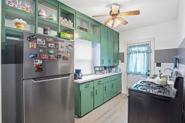 a kitchen with stainless steel appliances granite countertop a refrigerator and a stove top oven