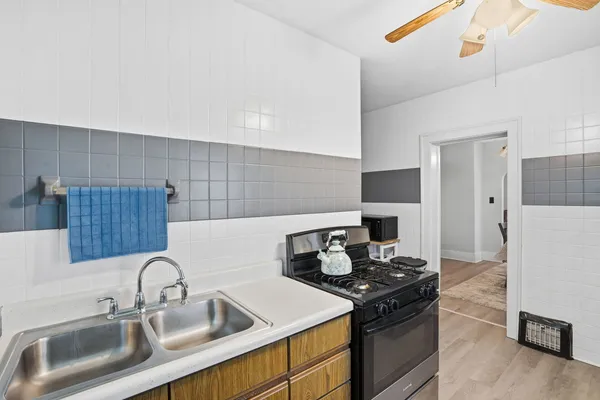 a kitchen with a sink cabinets and stainless steel appliances