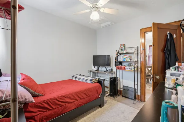 a bedroom with a bed and a flat screen tv