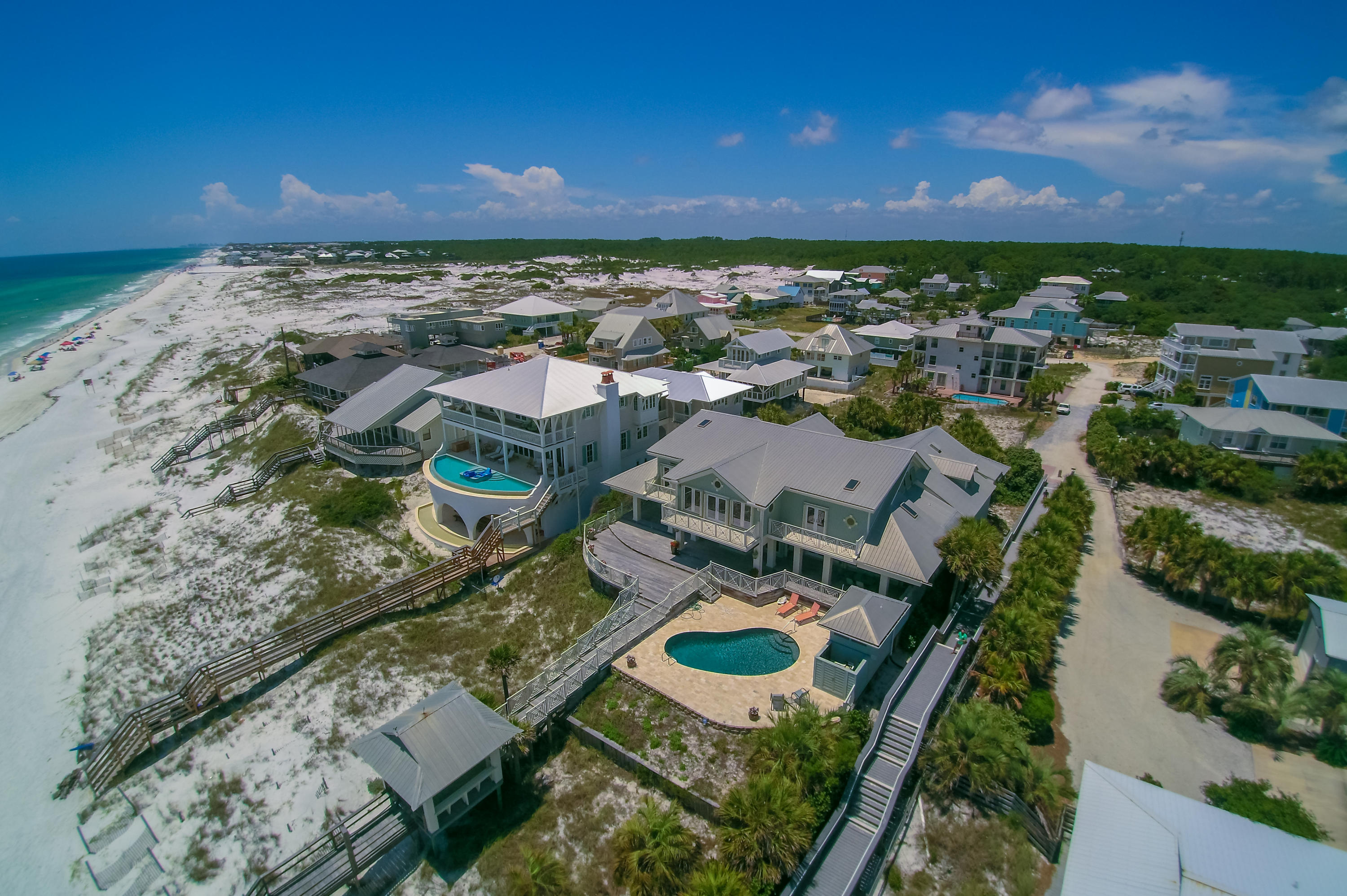 an aerial view of residential houses with outdoor space