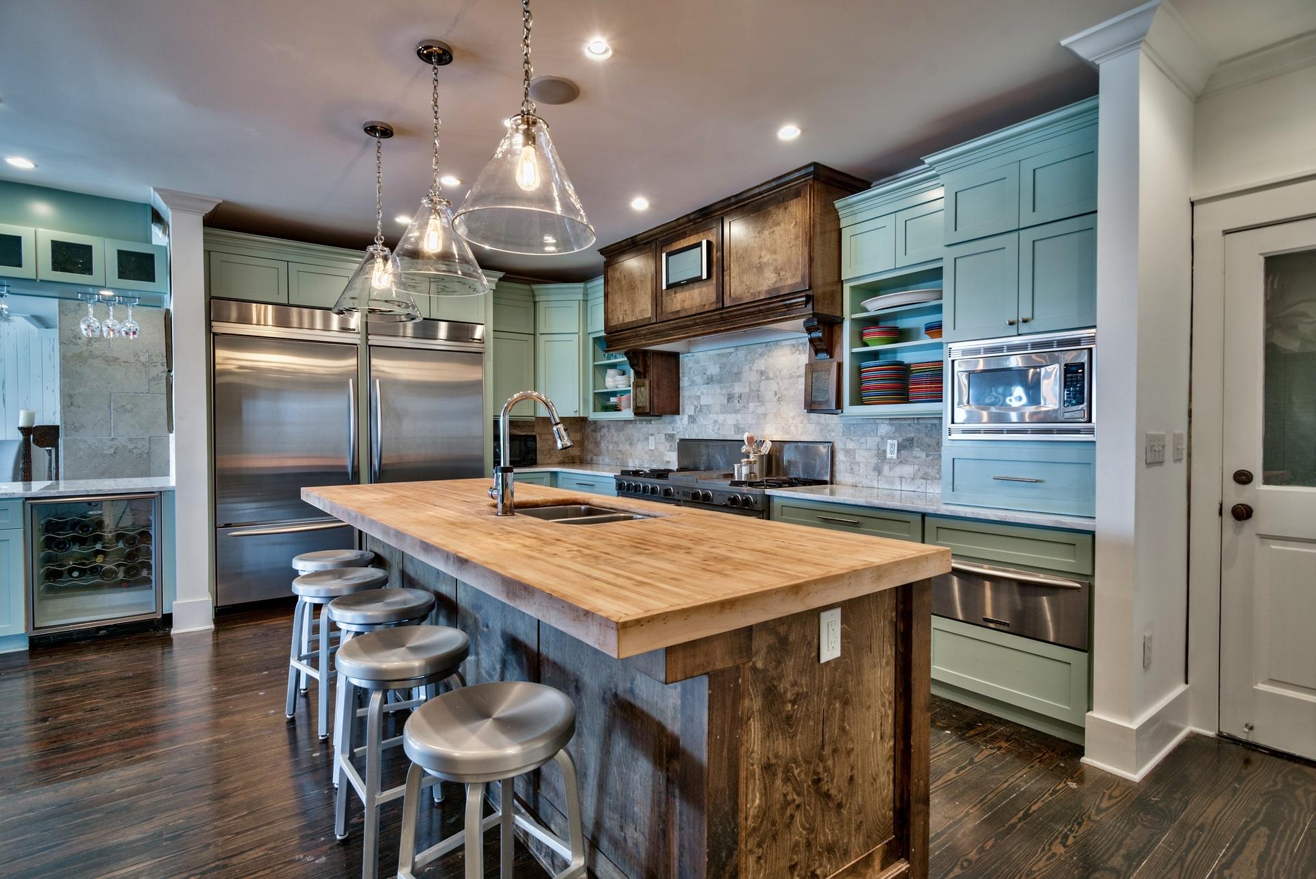 59 Auburn Drive Santa Rosa Beach, FL 32459 - Photo 26 of 71 a kitchen with stainless steel appliances granite countertop table chairs and wooden floor