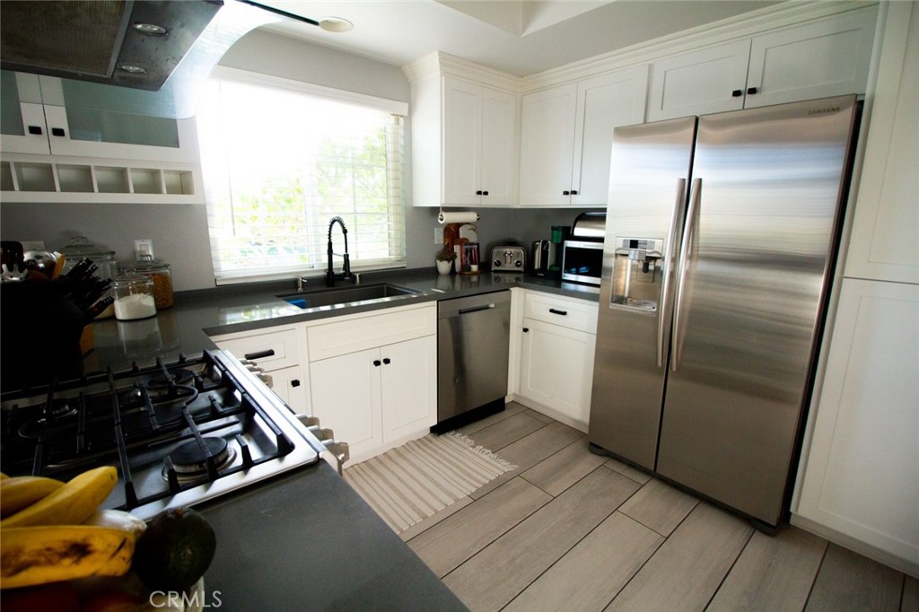 808 Gian Drive Torrance, CA 90502 - Photo 13 of 36 a kitchen with granite countertop a stove sink and refrigerator