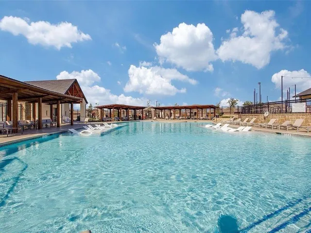 a view of a swimming pool with a table and chairs