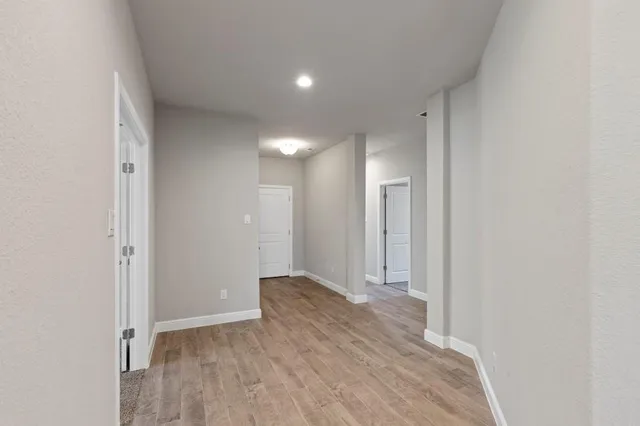 a view of hallway with wooden floor