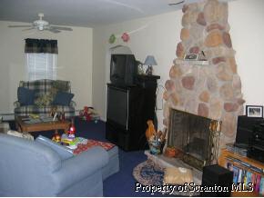 4 Point Rd Lake Factoryville, PA 18419 - Photo 3 of 5 a living room with furniture and a fireplace