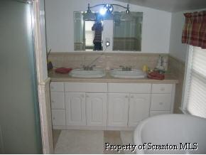 4 Point Rd Lake Factoryville, PA 18419 - Photo 5 of 5 a bathroom with a toilet a sink and mirror