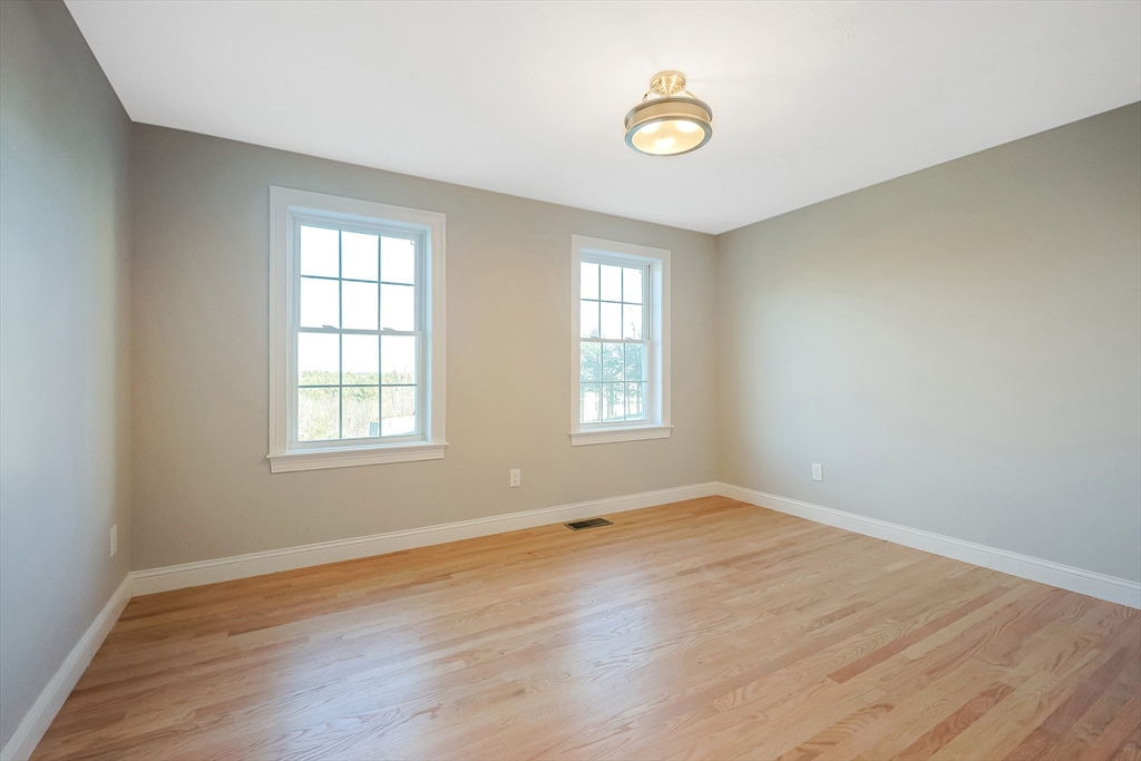 19 Oriole Drive Groton, MA 01450 - Photo 13 of 33 an empty room with wooden floor and windows