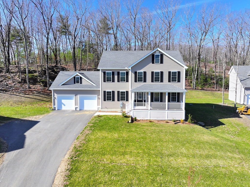 19 Oriole Drive Groton, MA 01450 - Photo 2 of 33 a front view of a house with a yard table and chairs