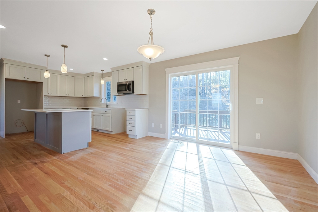 19 Oriole Drive Groton, MA 01450 - Photo 9 of 33 a view of kitchen with granite countertop cabinets and outdoor space