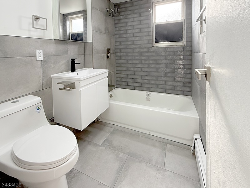 19 Van Rensselear Street, Unit 4 Belleville, NJ 07109 - Photo 9 of 10 a bathroom with a toilet and a sink