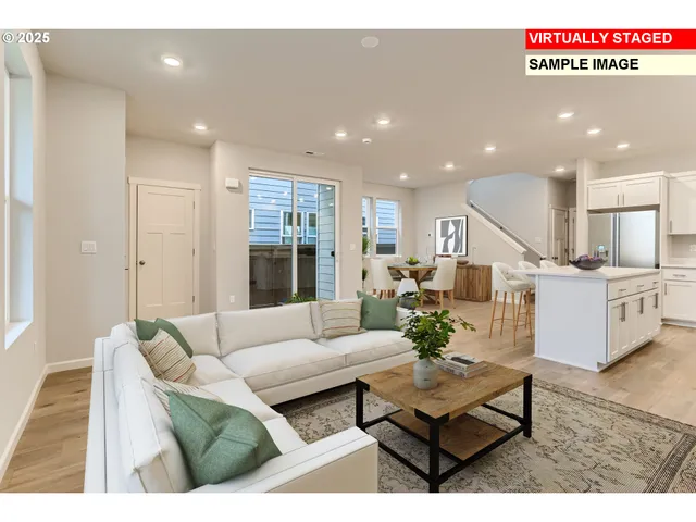 a living room with furniture kitchen view and a large window