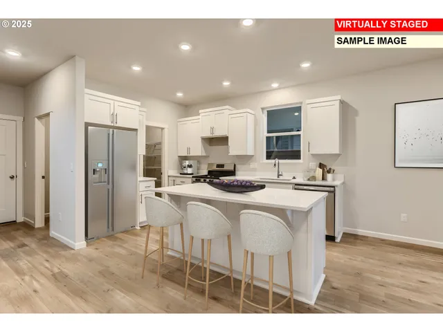 a kitchen with stainless steel appliances granite countertop a refrigerator a sink a stove a microwave and white cabinets