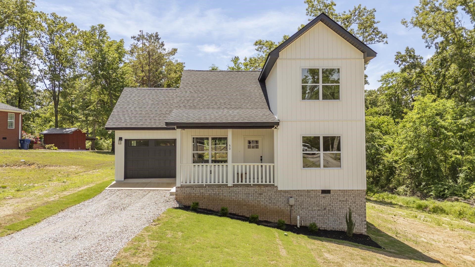 50 Fox Trot Road Adamsville, TN 38310 - Photo 1 of 40 a front view of a house with a yard and garage