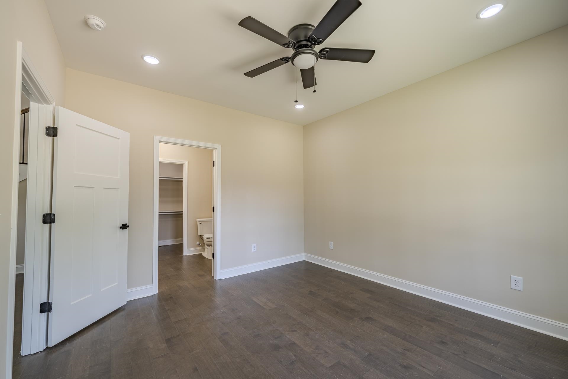 50 Fox Trot Road Adamsville, TN 38310 - Photo 13 of 40 an empty room with wooden floor and ceiling fan