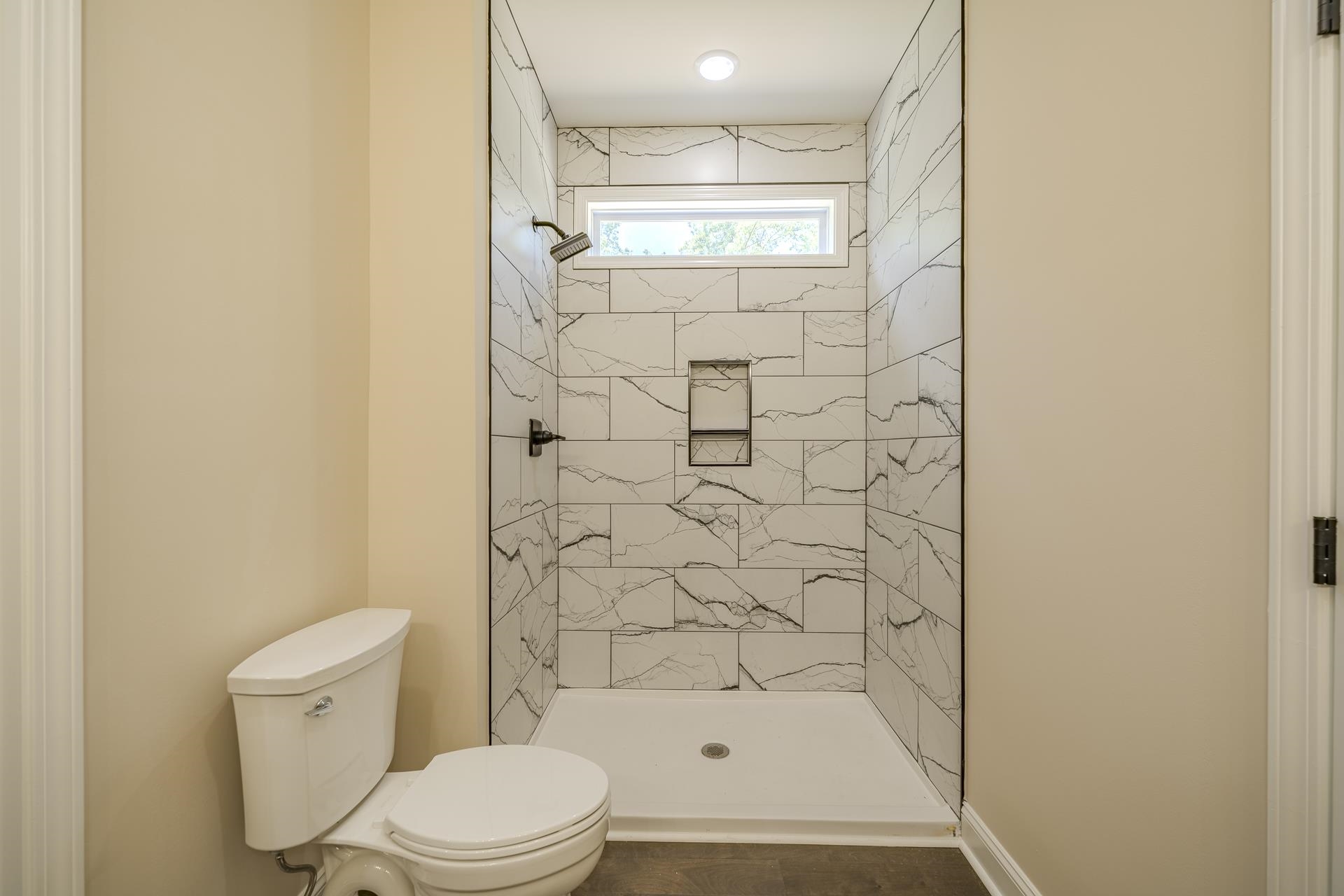 50 Fox Trot Road Adamsville, TN 38310 - Photo 16 of 40 a bathroom with a shower and a toilet