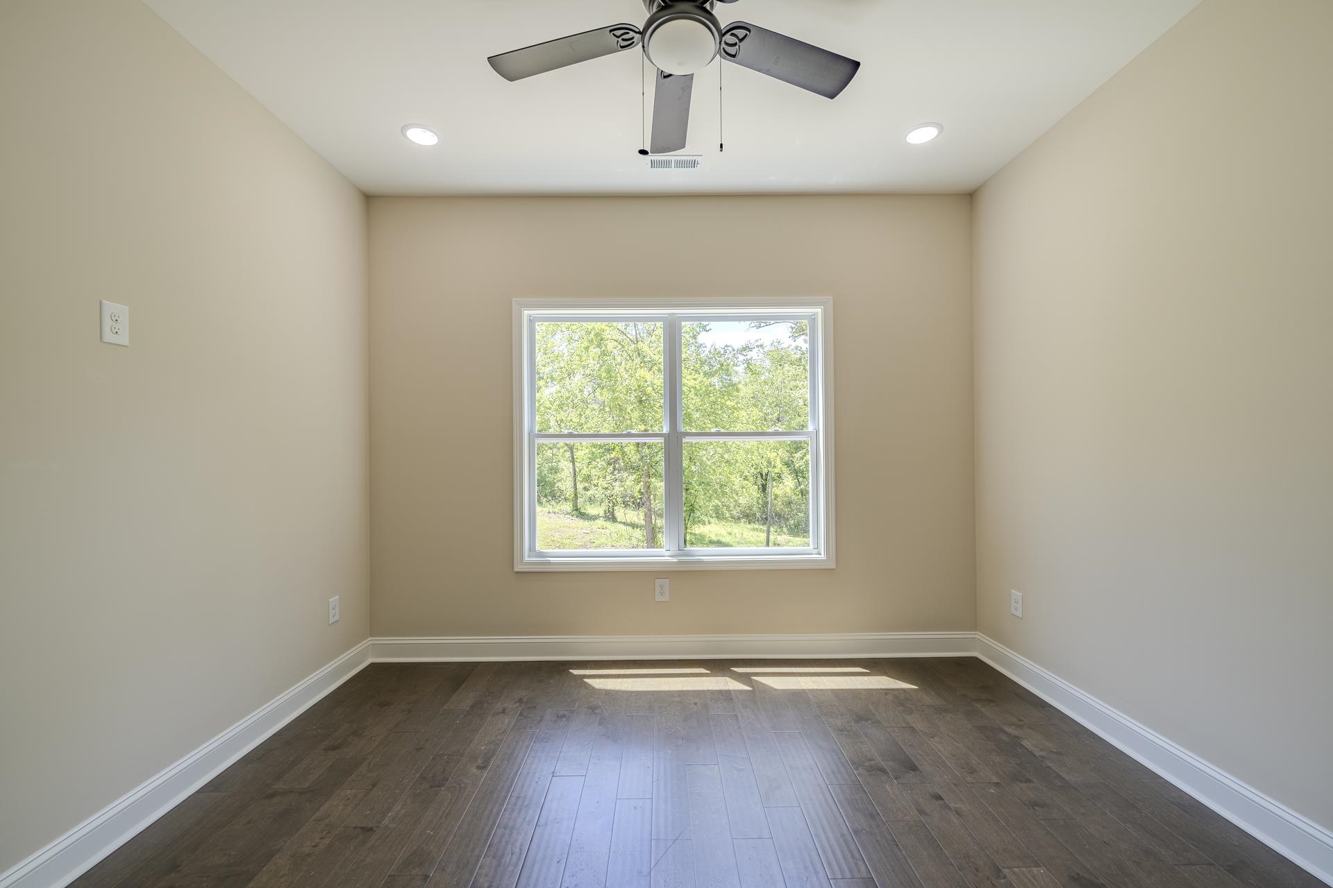 50 Fox Trot Road Adamsville, TN 38310 - Photo 25 of 40 an empty room with wooden floor and windows