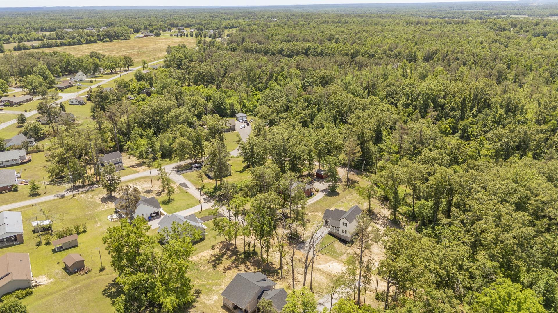 50 Fox Trot Road Adamsville, TN 38310 - Photo 40 of 40 an aerial view of residential houses with outdoor space and trees