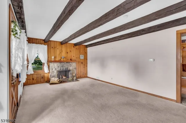 a view of a livingroom with fireplace and window