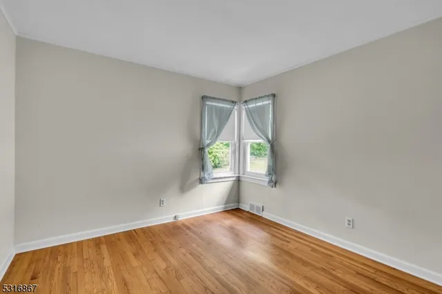 a view of a livingroom with furniture and wooden floor