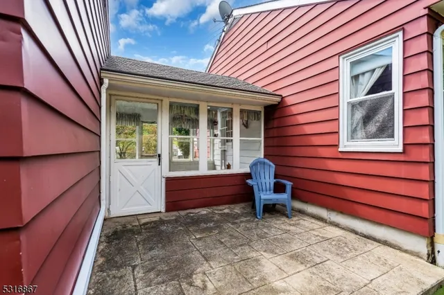 a front view of a house with a bench