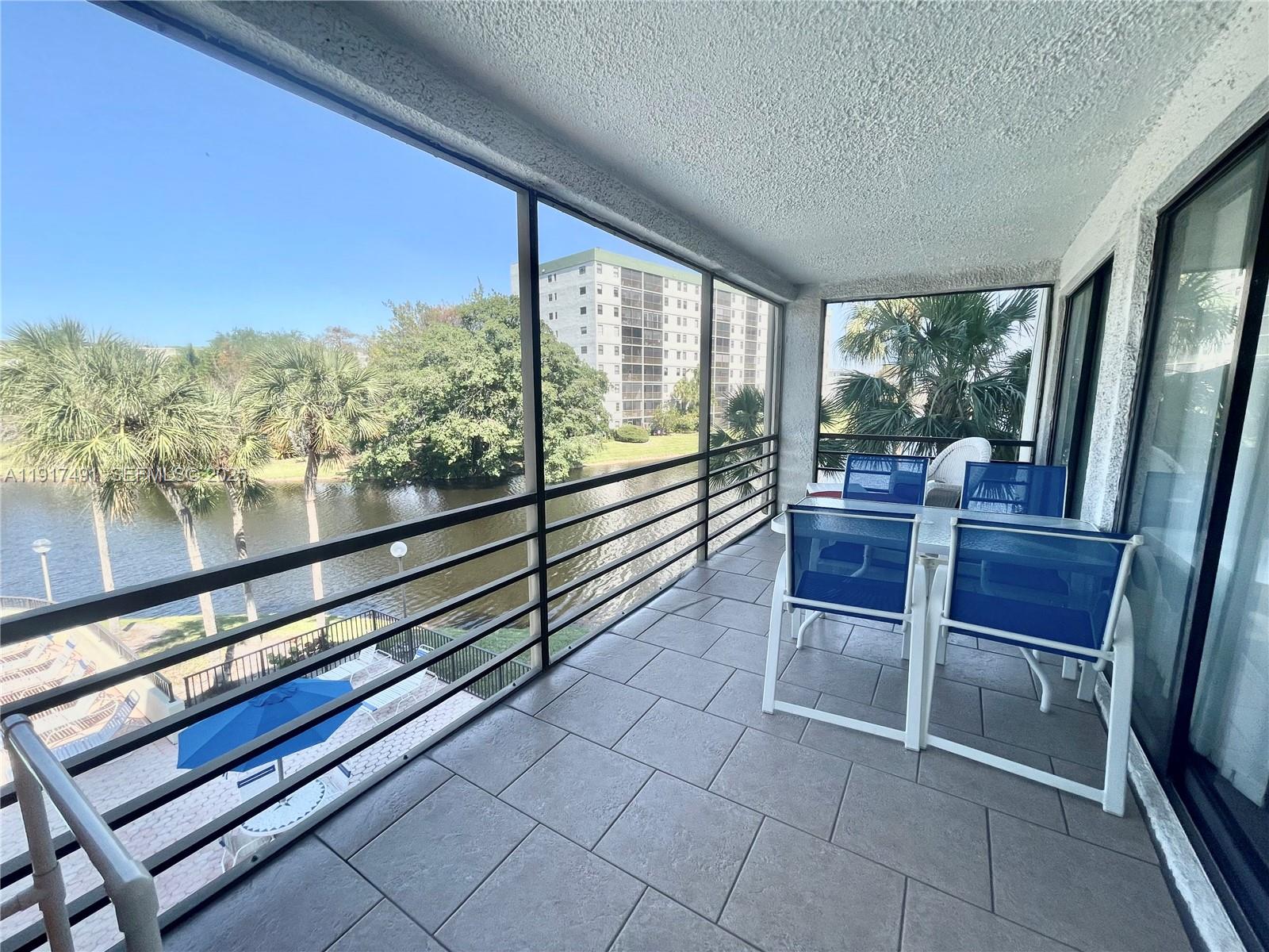 2309 South Cypress Bend Drive, Unit 311 Pompano Beach, FL 33069 - Photo 16 of 51 a view of a chairs and table in a balcony