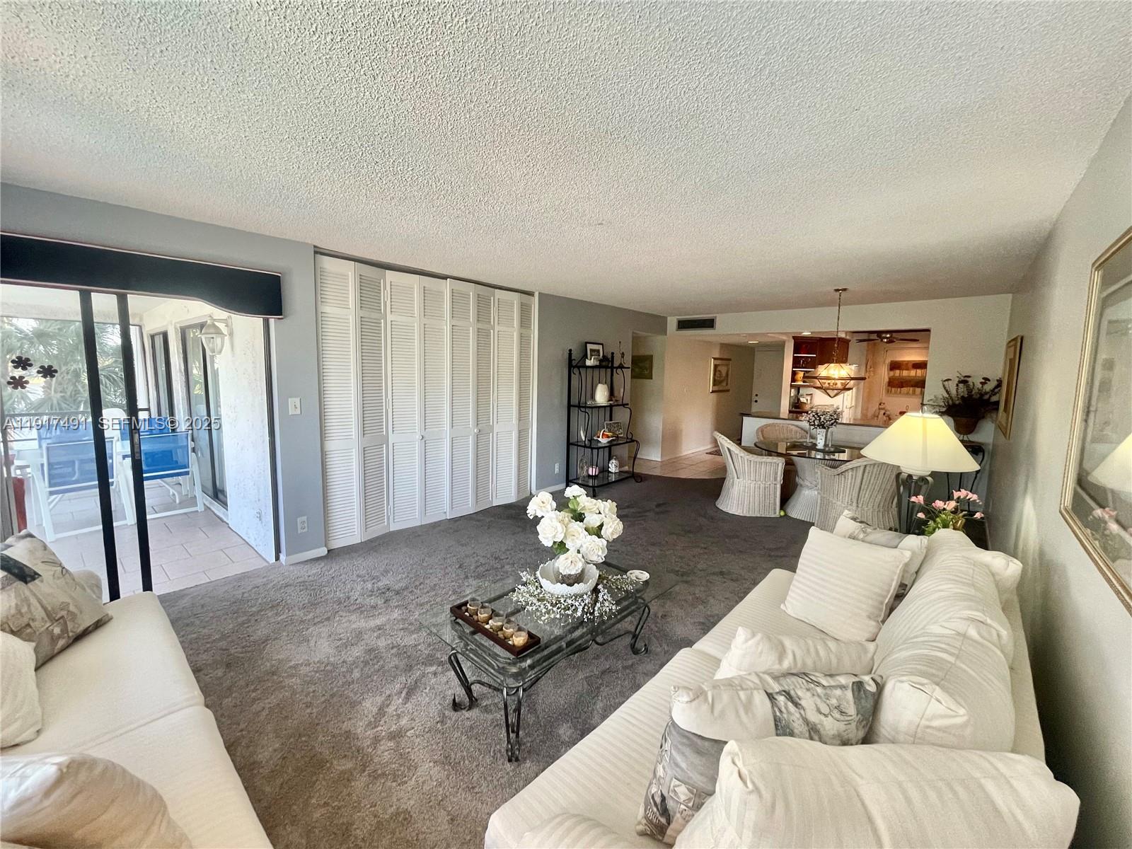 2309 South Cypress Bend Drive, Unit 311 Pompano Beach, FL 33069 - Photo 19 of 51 a living room with furniture flowerpot and wooden floor