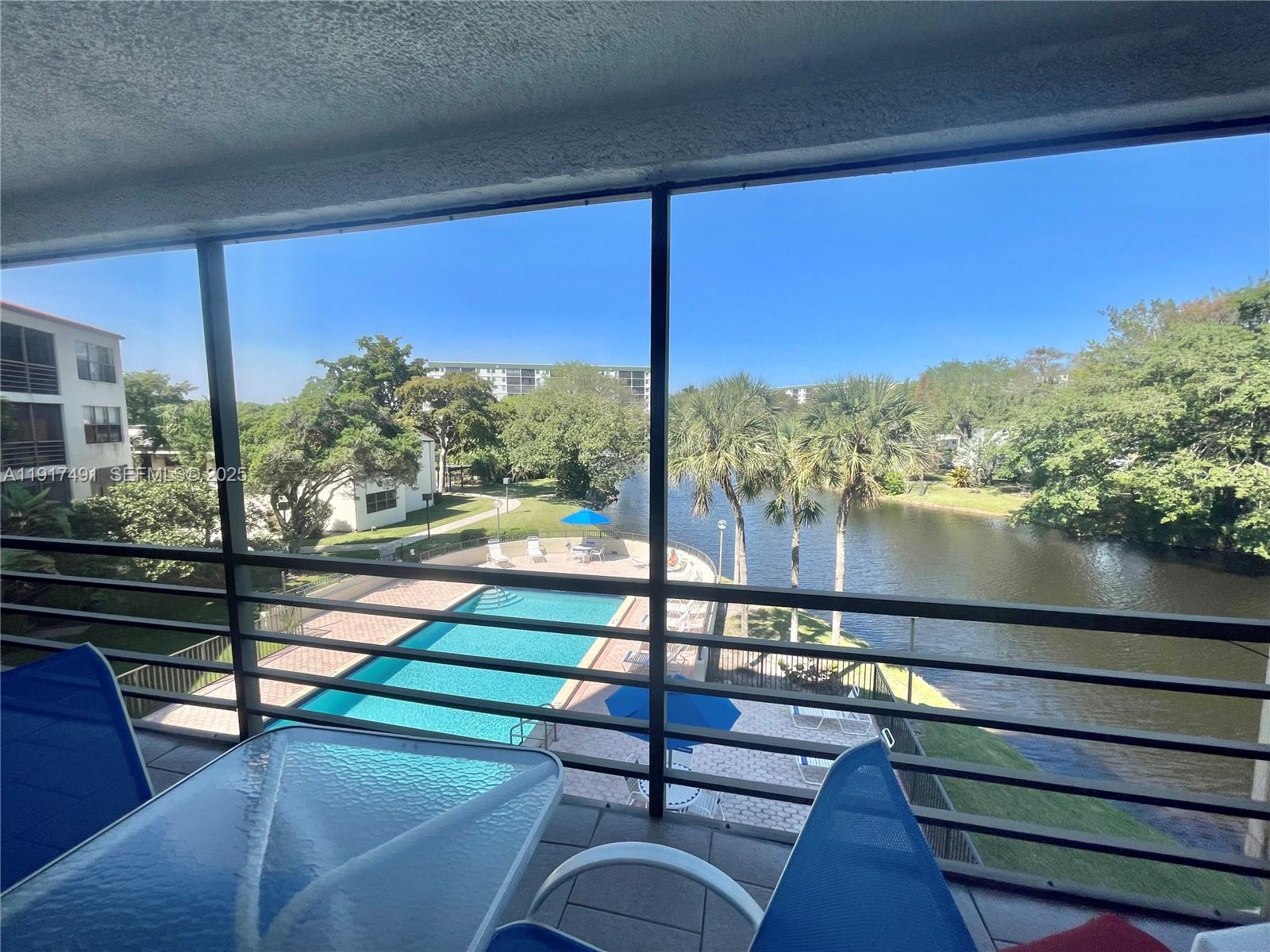 2309 South Cypress Bend Drive, Unit 311 Pompano Beach, FL 33069 - Photo 22 of 51 a view of a balcony with chairs and a table