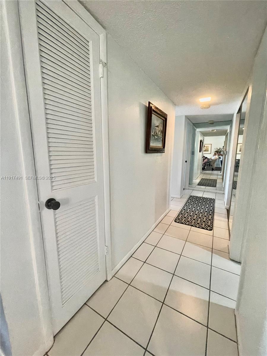 2309 South Cypress Bend Drive, Unit 311 Pompano Beach, FL 33069 - Photo 24 of 51 a bedroom with a bed and a window