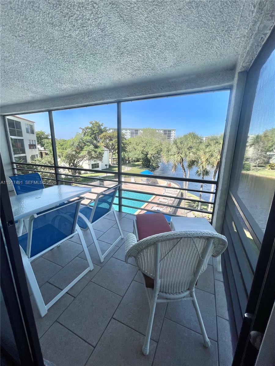 2309 South Cypress Bend Drive, Unit 311 Pompano Beach, FL 33069 - Photo 32 of 51 a view of a floor to ceiling window with wooden floor