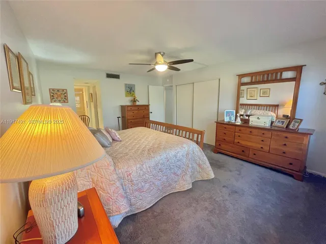 a spacious bedroom with a bed and wooden floor