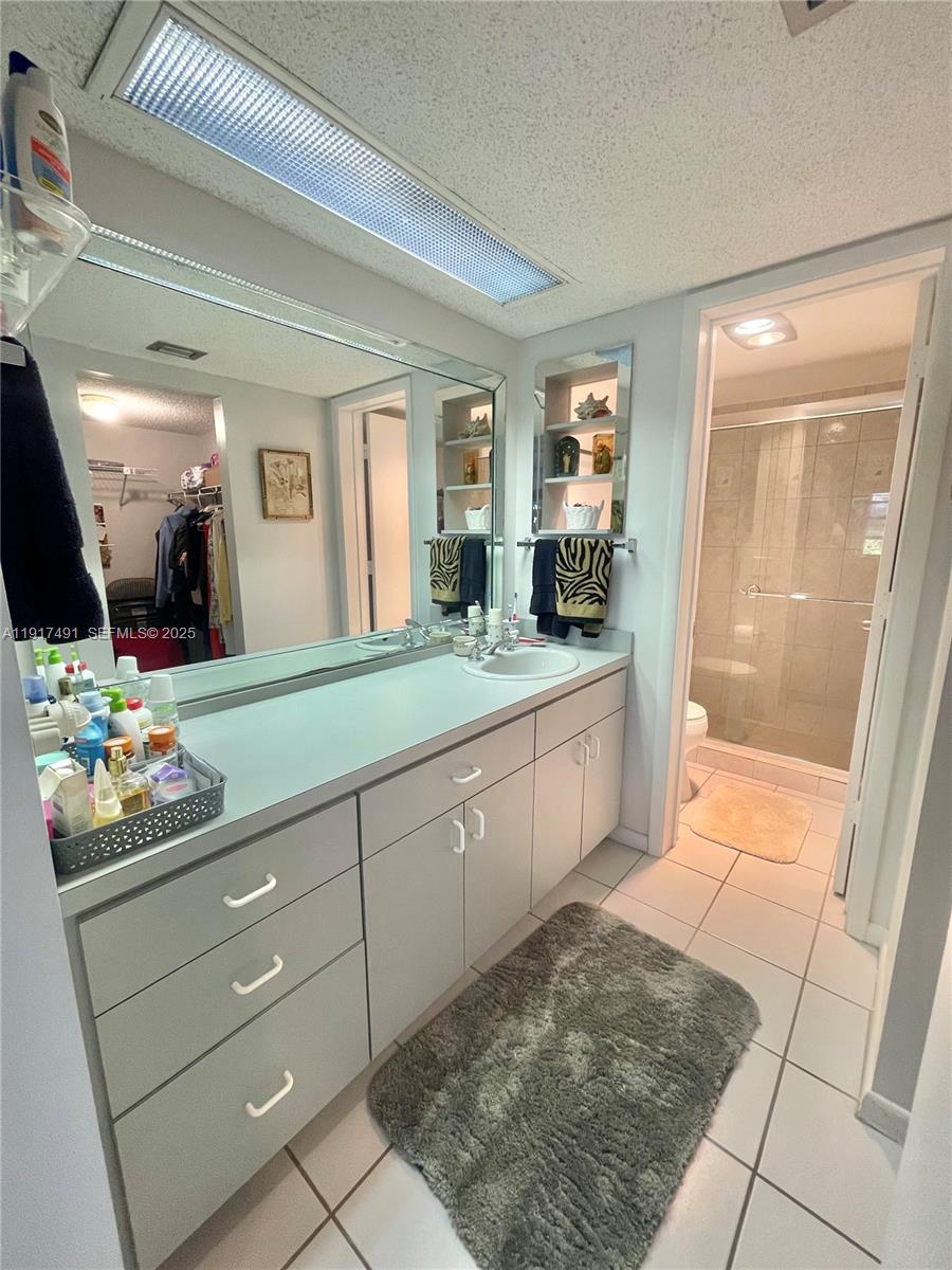 2309 South Cypress Bend Drive, Unit 311 Pompano Beach, FL 33069 - Photo 38 of 51 a spacious bathroom with a sink mirror and vanity
