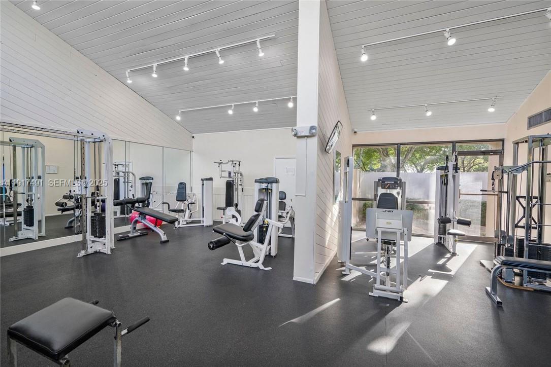 2309 South Cypress Bend Drive, Unit 311 Pompano Beach, FL 33069 - Photo 48 of 51 a view of a room with gym equipment
