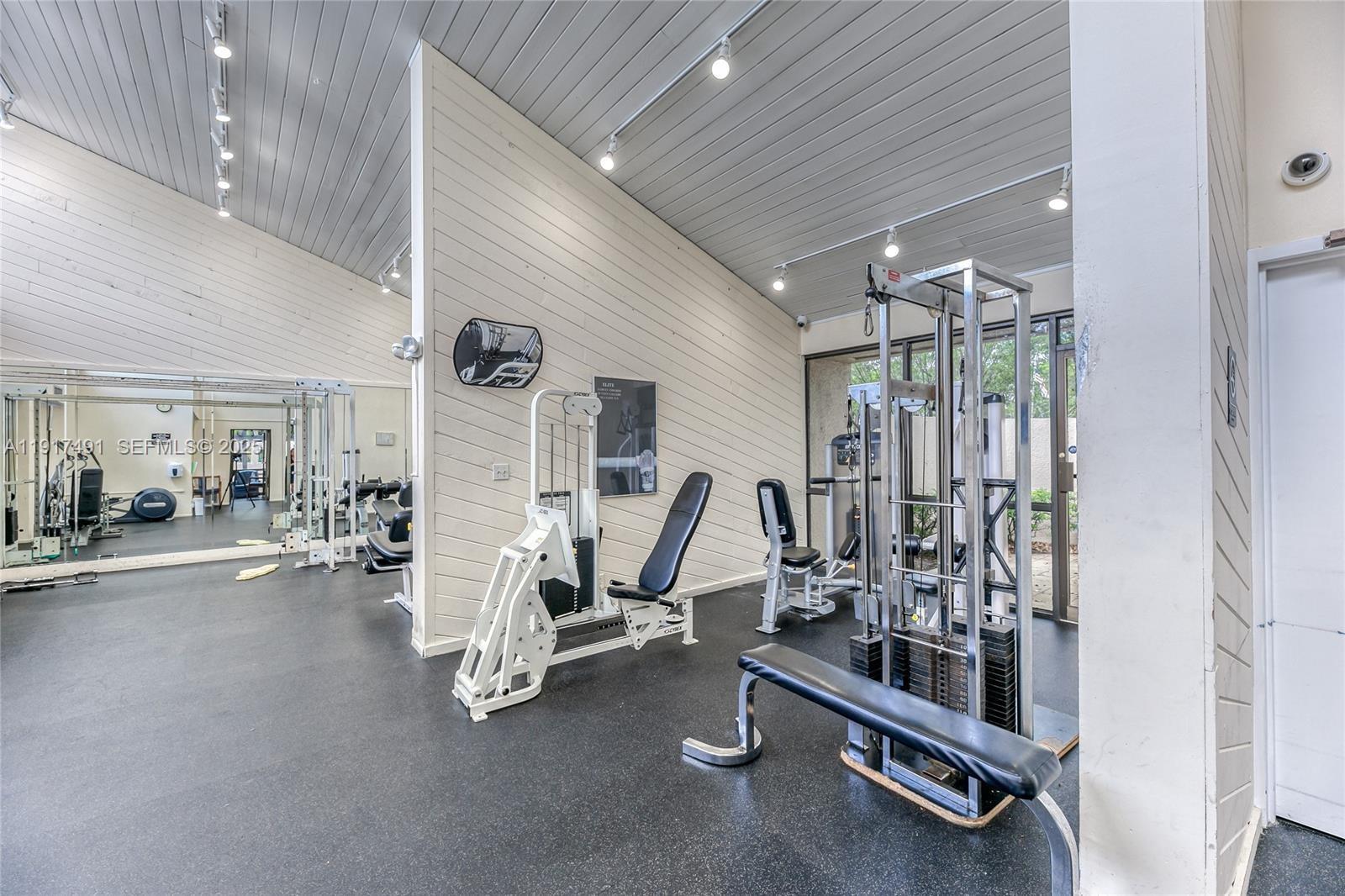 2309 South Cypress Bend Drive, Unit 311 Pompano Beach, FL 33069 - Photo 50 of 51 a view of a room with gym equipment