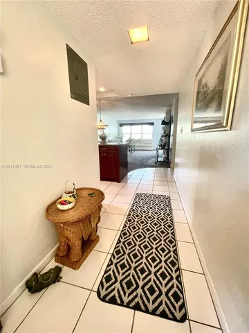 a hallway with a table and chairs