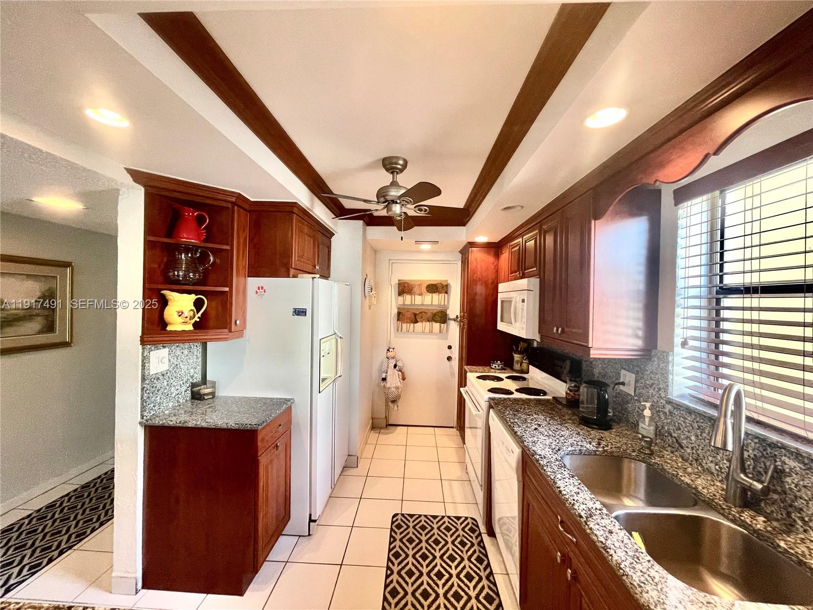 2309 South Cypress Bend Drive, Unit 311 Pompano Beach, FL 33069 - Photo 8 of 51 a kitchen with stainless steel appliances granite countertop a sink stove and refrigerator