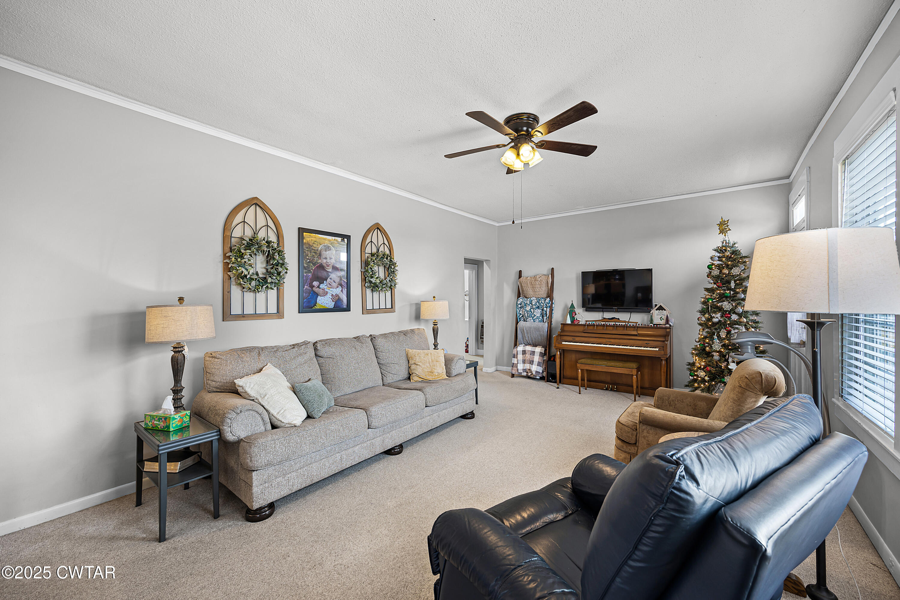 7 Herron Street Jackson, TN 38301 - Photo 12 of 19 a living room with furniture a clock on wall and a table
