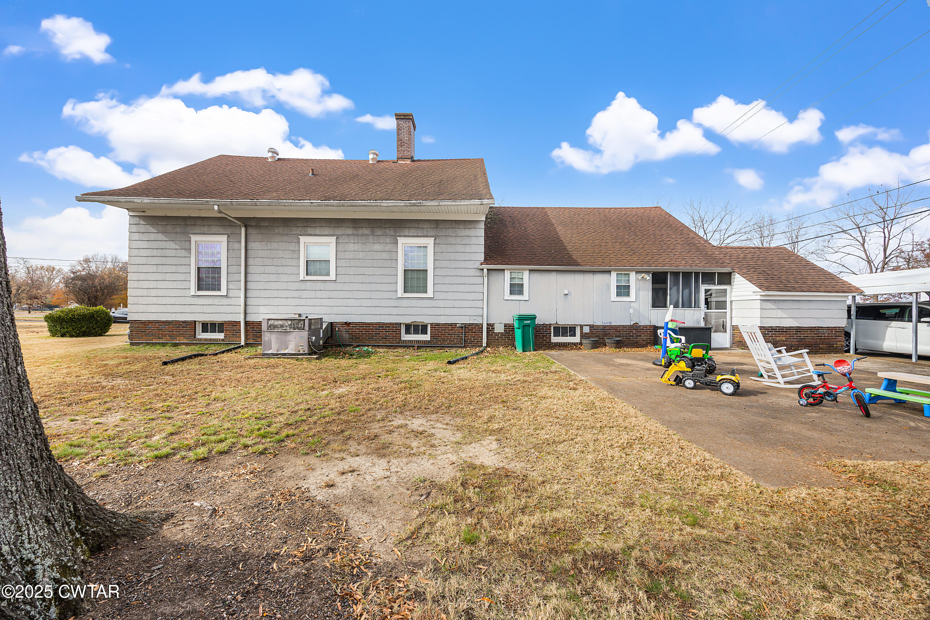 7 Herron Street Jackson, TN 38301 - Photo 3 of 19 a view of a house with a backyard and a table and chairs under an umbrella