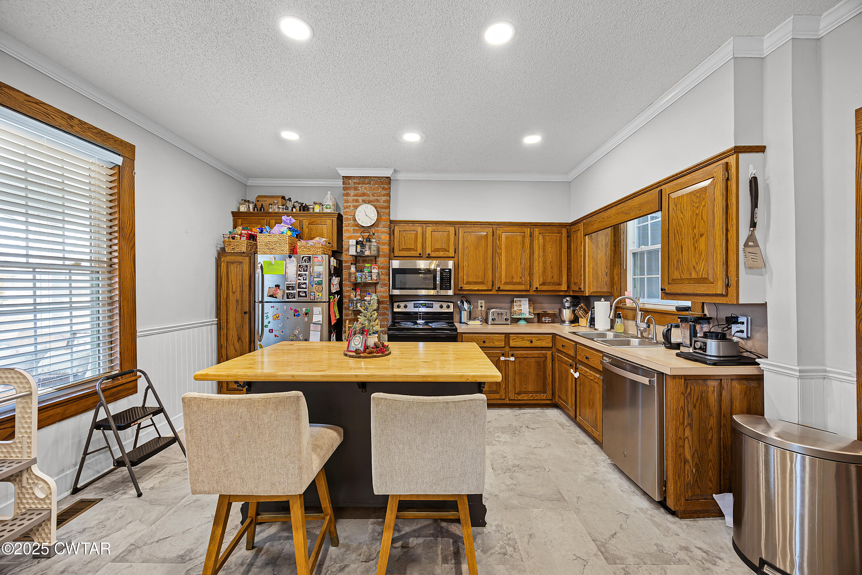 7 Herron Street Jackson, TN 38301 - Photo 5 of 19 a kitchen with stainless steel appliances granite countertop a sink a stove a refrigerator cabinets and chairs
