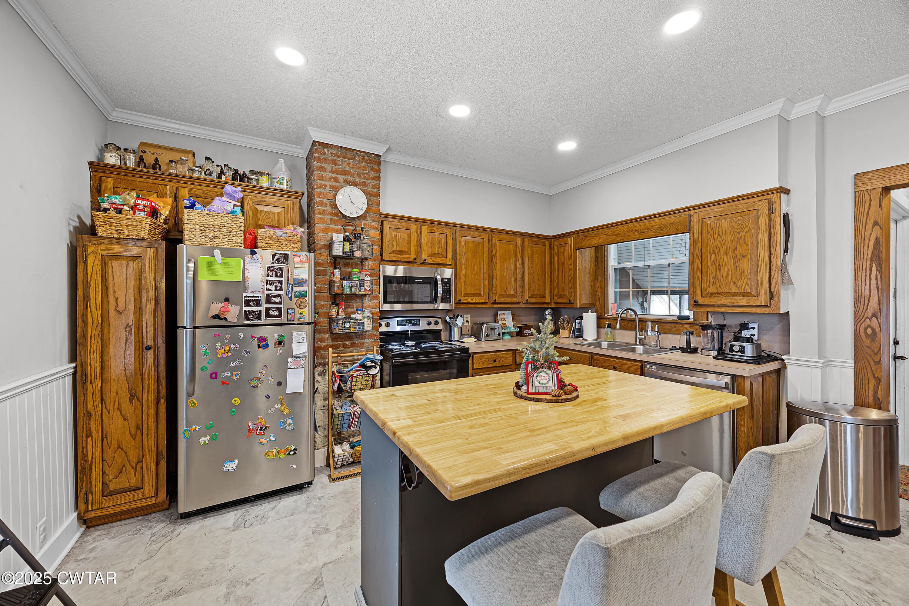 7 Herron Street Jackson, TN 38301 - Photo 6 of 19 a kitchen with stainless steel appliances granite countertop a sink refrigerator and cabinets