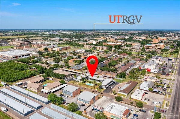 an aerial view of a residential apartment building with a yard