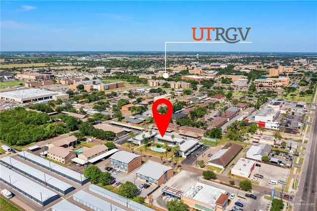 an aerial view of a residential apartment building with a yard