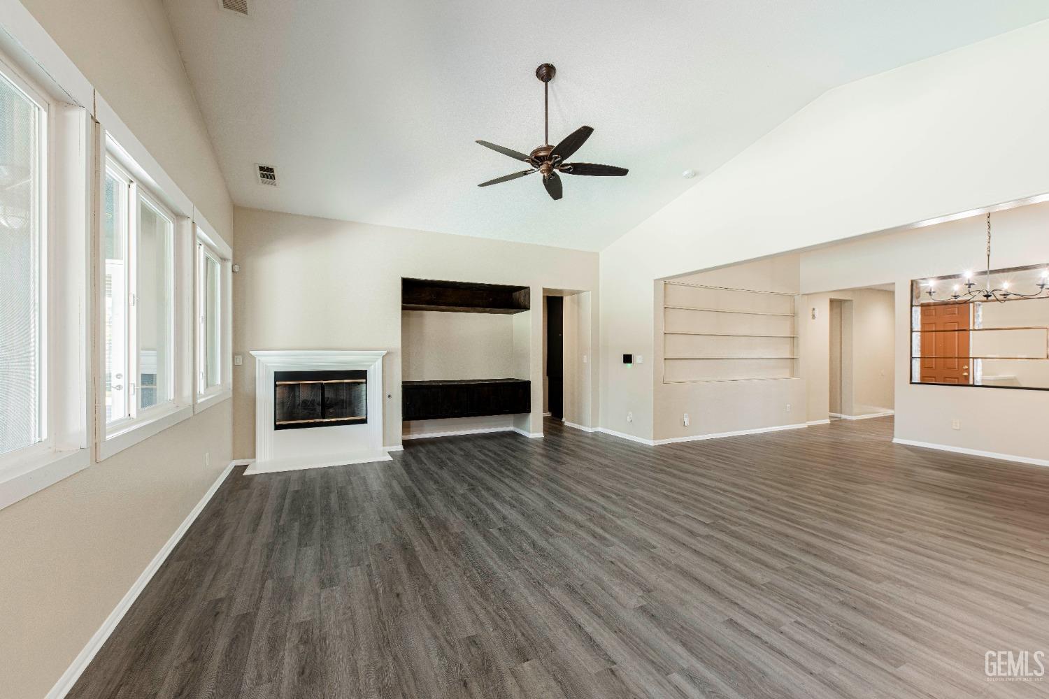 Undisclosed Address Bakersfield, CA 93312 - Photo 11 of 44 a view of a livingroom with wooden floor and a ceiling fan